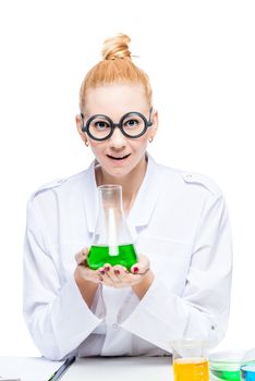 Beautiful blonde in round funny glasses with a bulb with green liquid