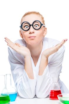 funny lab assistant in white lab coat sits at table in laboratory