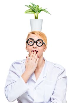 Portrait of a funny doctor in round glasses with a flower pot on his head isolated