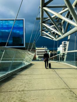 One businessman with luggage goes to the station, A man heading off on a business trip. Thunderstorm is coming