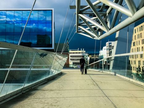 One businessman with luggage goes to the station, A man heading off on a business trip. Thunderstorm is coming