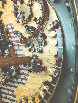 Visitors at the coffee shop in the shopping center in Stockholm, Sweden. Top view, from above