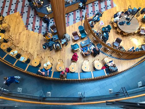 Visitors at the coffee shop in the shopping center in Stockholm, Sweden. Top view, from above