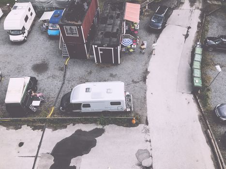 Trucks settlement. Aerial view of camping in Stockholm, Sweden. Summer seascape with trucks, sunny day. Top view from flying drone