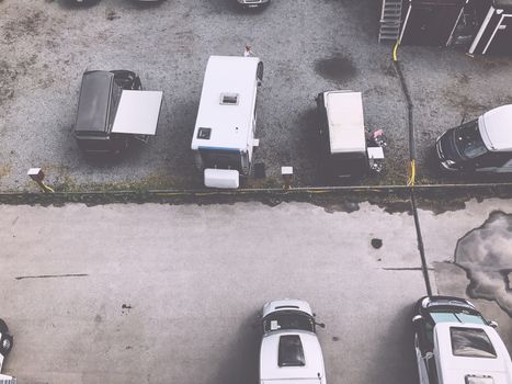 Trucks settlement. Aerial view of camping in Stockholm, Sweden. Summer seascape with trucks, sunny day. Top view from flying drone