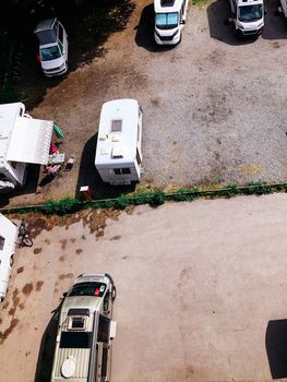 Trucks settlement. Aerial view of camping in Stockholm, Sweden. Summer seascape with trucks, sunny day. Top view from flying drone