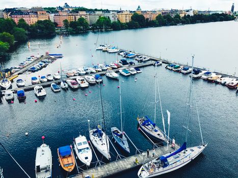 Beautiful boats. Aerial view of colorful boats in Stockholm, Sweden. Summer seascape with ships, sunny day. Top view, yachts from flying drone