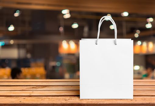 white paper bag for shopping on a wooden background