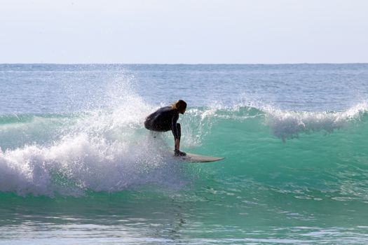 Surfer surfing the waves in the Caribbean Sea