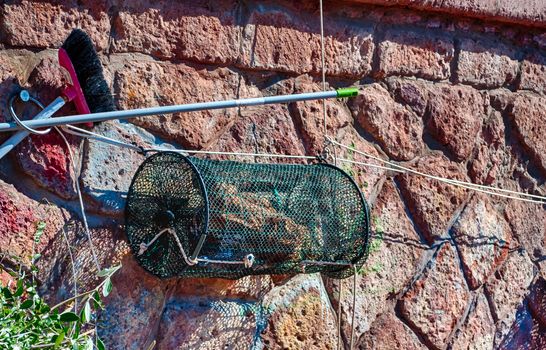 Closeup of fishing net in a harbor in a sunny morning of summer - Bosa - Sardinia - Italy