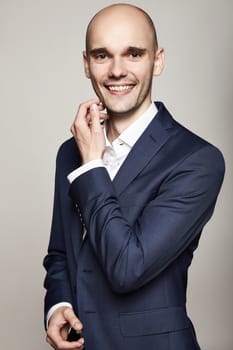 Portrait of handsome man looking at the camera. Portrait on gray background.