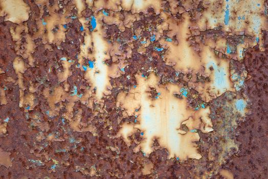 Old rusty metal grunge background with blue paint flaking and cracking texture