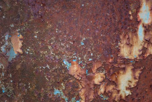 Old rusty metal grunge background with blue paint flaking and cracking texture