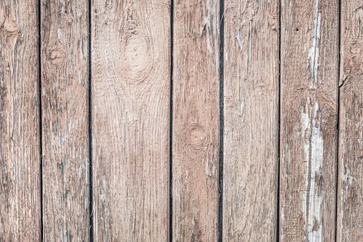 Wooden grunge background from the old brown unpainted boards closeup