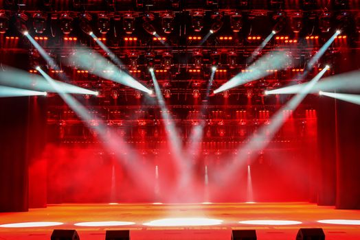Illuminated concert stage without people, with red light and stage fog