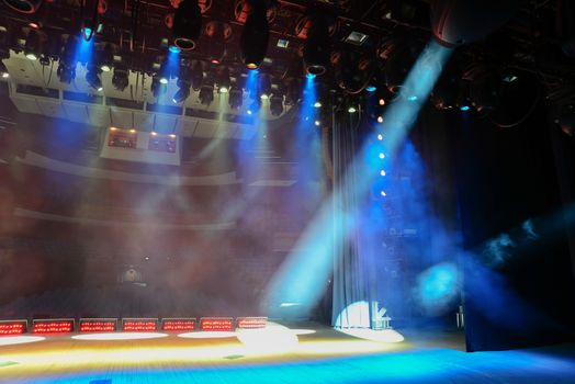 View from the illuminated empty show stage to the dark auditorium