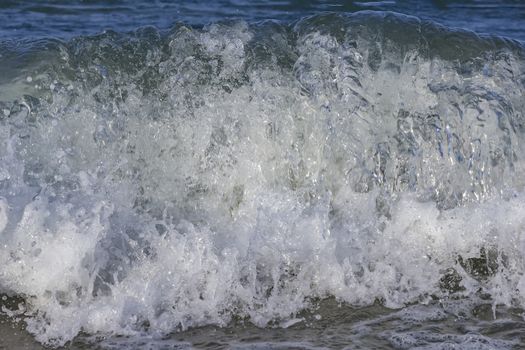 Churning blue water in the sea shows lots of turbulence and splash. freshness