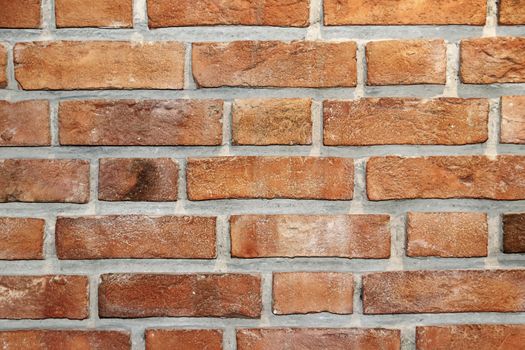 Wall of burnt bricks handmade closeup textured background