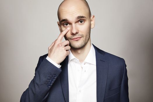 Portrait of young businessman on gray background.