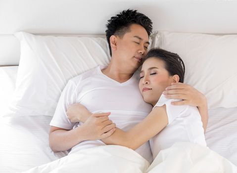 Young loving couple in the bed. Modern lifestyle concept