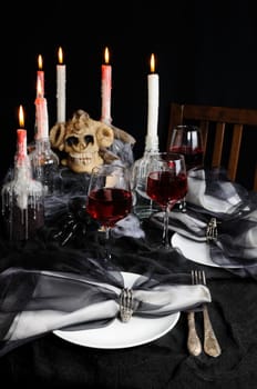 Napkin with a clip in the form of a skeleton of a brush as an element of a decor of a holiday table for Halloween