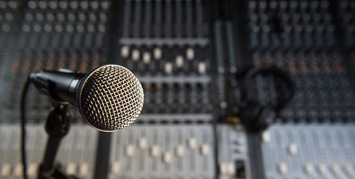 Microphone and Headphones on dirty sound mixer panel, France