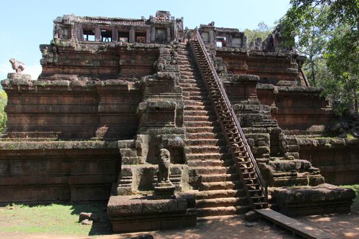 The setting sun rays on the walls of the ancient city of Angkor in Cambodia, near Siem Reap