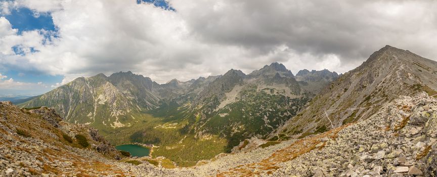 Alpine lake Popradske pleso in the morning with a great view on Tatra mountains.