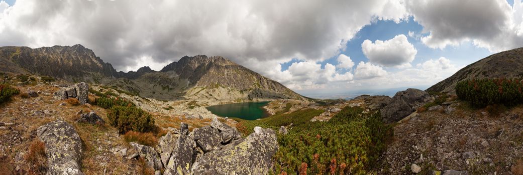 Panorama of valley with beautiful alpine lake ander highest peak of Tatra Mountains - Gerlachovsky stit