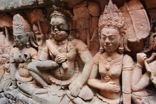 A beautiful ancient relief on the wall of a Cambodian Buddhist temple from Angkor complex, near the antique city of Siem Reap.