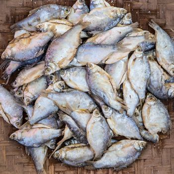 Mackerel fishes in round bamboo basket for sale in local market in Asia.