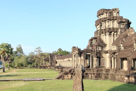 The ruins of a temple in the complex of Angkor, near the ancient city of Siem Reap. Black and gray stones, jungle around