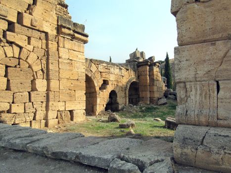 The ruins of an ancient Greek city in the background of hills and green cypresses. Turkey