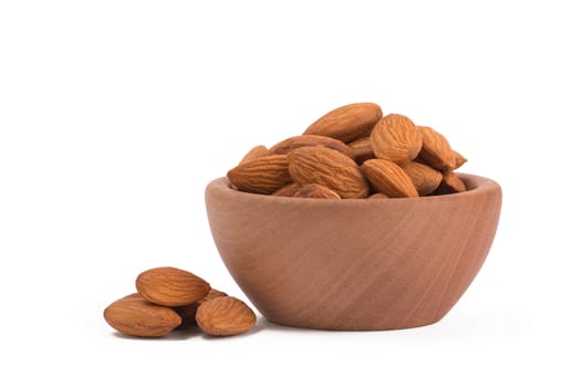 Bio organic almonds in wooden bowl isolated on white background,