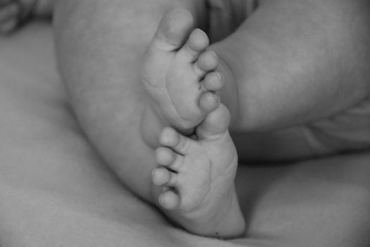 Baby, infant feet black and white photo, beautiful background for card,  banner, wallpaper design 