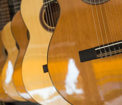 Many Classical Guitars Hanging on Wall in the Shop, France
