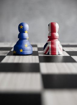 Two pawns with UK and European flags on a chess board