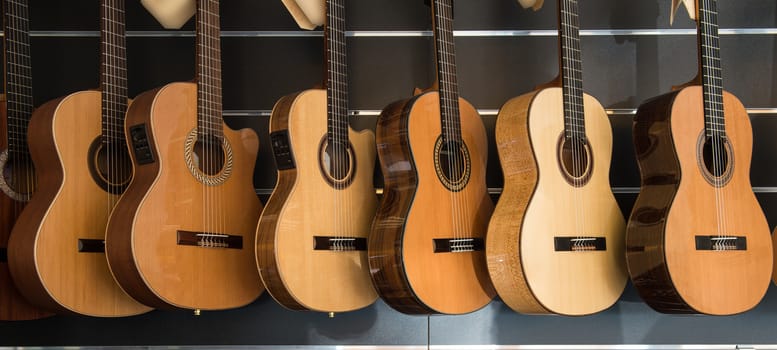 Many Classical Guitars Hanging on Wall in the Shop, France