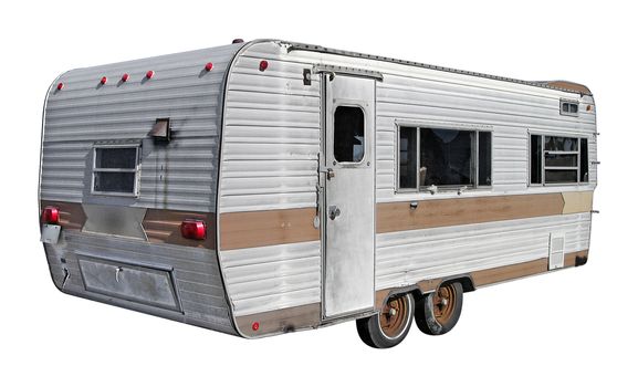 A recreational vehicle trailer from the past, isolated from the background. Also contains a clipping path.