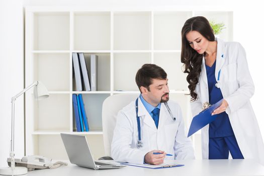 Doctors in a white labcoats discuss RX prescription, diagnosis