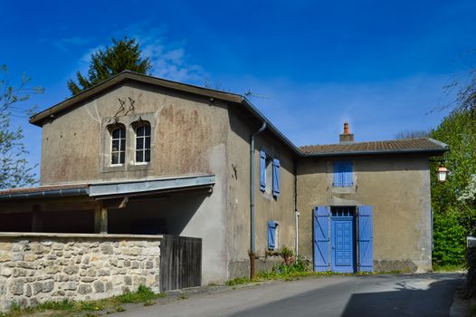 Small house with blue shutters in a small village near the lake of madine in the department of the meuse in France