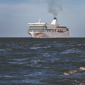 White cruise liner sailing on a clear day