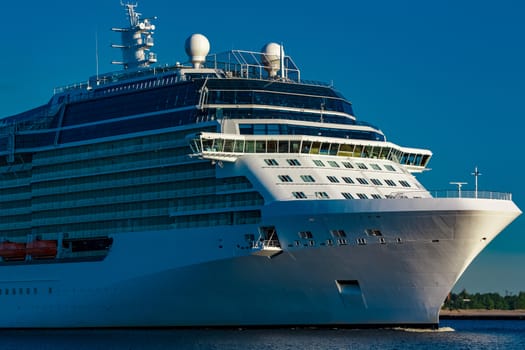 White giant brand new passenger ship moving in clear summer day