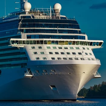 White giant brand new passenger ship moving in clear summer day