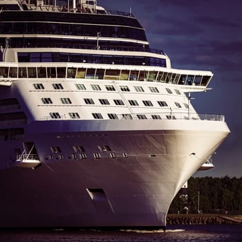 White giant brand new passenger ship moving in clear summer day