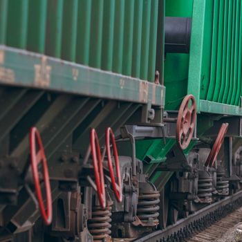 Green cargo wagons. Freight train in action