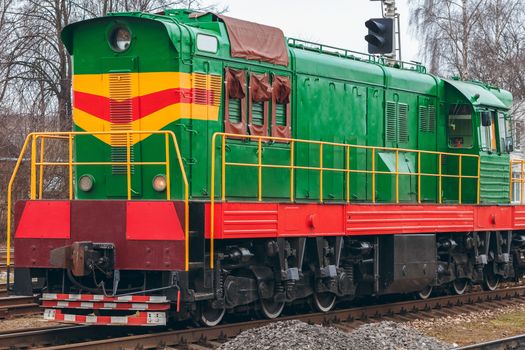 Green diesel cargo locomotive. Freight train in action