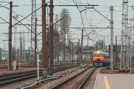 Old yellow passenger diesel train moving at the terminal