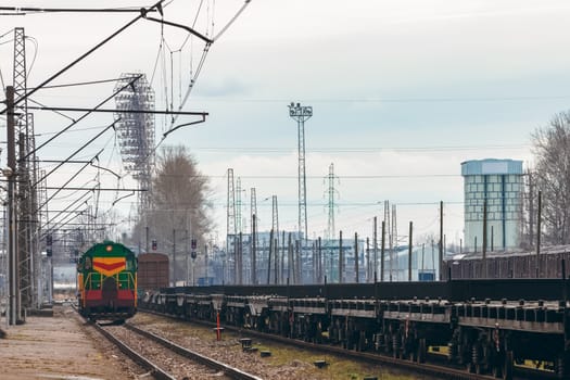 Green diesel cargo locomotive. Freight train in action