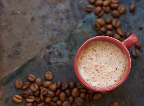 Hot coffee latte cappuccino witl milk foam in vintage ceramic cup on texture background.